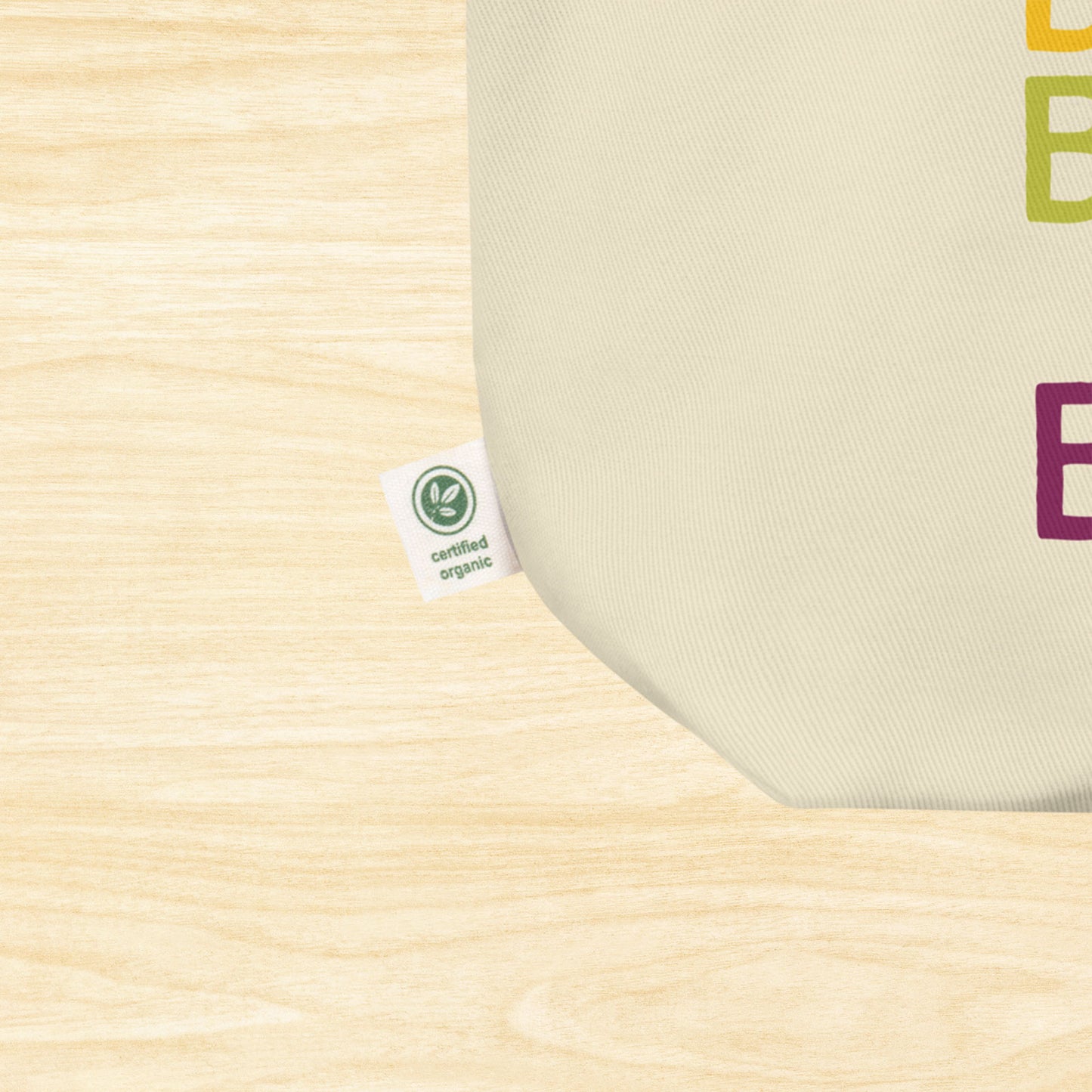 Close up of a cotton tote bag, showing only the corner of the bag