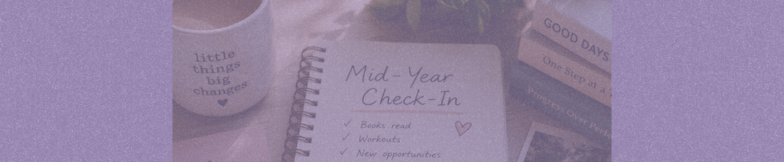A cozy desk scene featuring an open notebook titled “Mid-Year Check-In,” surrounded by a coffee mug, stacked books, and photos, symbolizing reflection, personal growth, and a mid-year life reset.