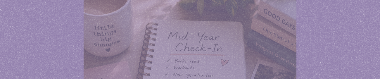 A cozy desk scene featuring an open notebook titled “Mid-Year Check-In,” surrounded by a coffee mug, stacked books, and photos, symbolizing reflection, personal growth, and a mid-year life reset.